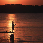 A Silhouette of a Young Boy at Sunset