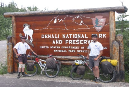 Bicyclists at the Denali National Park Welcome Sign
