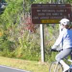 Biking past Directional Sign in Cape Lookout National Seashore