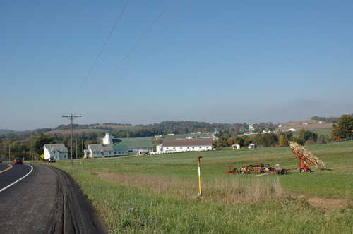 Farm and Farm Equipment in a Field near Winesburg