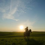 Cowboy in pasture near Flint Hills National Scenic Byway in Kansas.