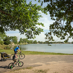 Cyclists ride near the Arkansas River in Kansas.